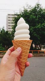 Close-up of hand holding ice cream cone