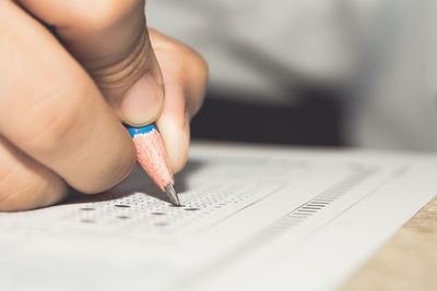 Close-up of hand writing on paper