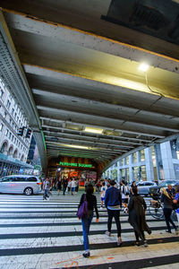 People walking in illuminated city