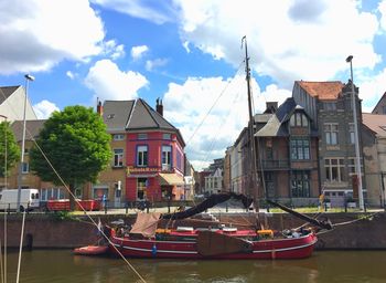 Boats in river with buildings in background