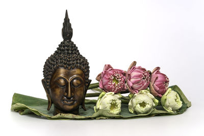 Close-up of statue against white background