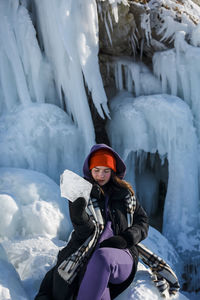 Portrait of woman standing on snow