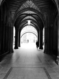 Rear view of man walking in corridor