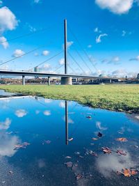 Scenic view of bridge over lake against blue sky