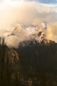 Scenic view of snowcapped mountains against sky during sunset