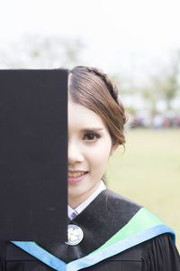 Portrait of smiling woman in graduation gown