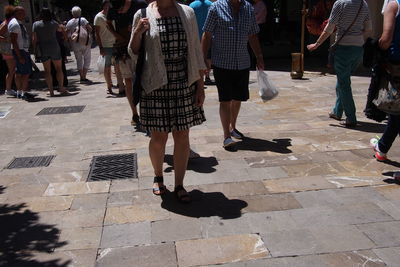 Woman standing on footpath