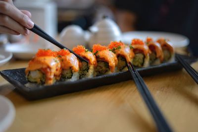 Close-up of person preparing food on table