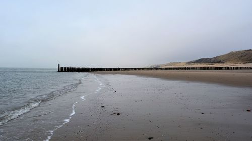 Scenic view of beach against clear sky