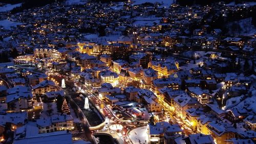 High angle view of city lit up at night