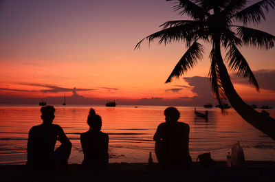 Scenic view of sea against dramatic sky during sunset