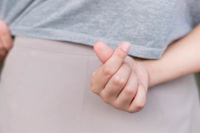 Midsection of woman gesturing