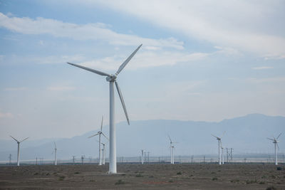 Windmill on field against sky