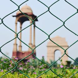 India gate seen through chainlink fence