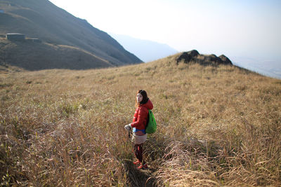 Portrait of woman standing on field