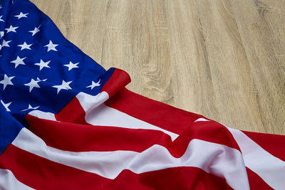 Close-up of american flag on wooden floor