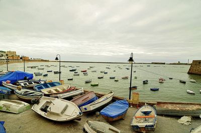 High angle view of boats moored at beach against sky