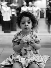 Cute girl sitting outdoors