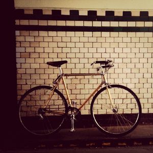 Bicycle parked against wall