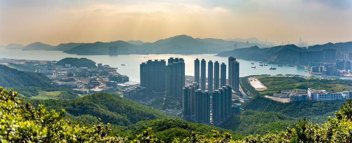 Panoramic view of city against cloudy sky