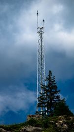 Low angle view of communications tower against sky