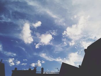 Low angle view of building against cloudy sky