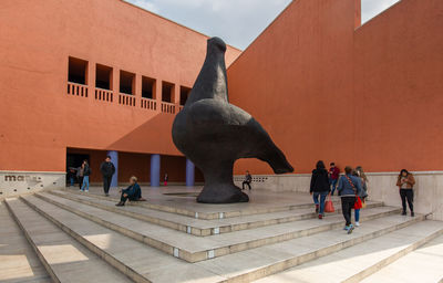 Statue of people in front of building