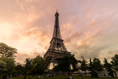 Low angle view of eiffel tower against cloudy sky