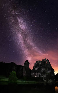 Silhouette mountain against sky at night