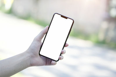 Close-up of hand holding mobile phone