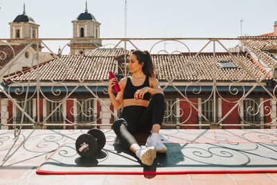 Sportswoman having a water break after exercising.