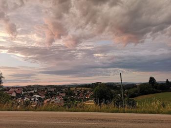Trees on field against sky at sunset