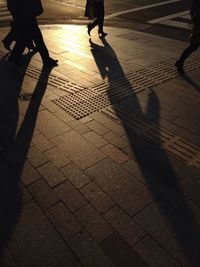 Low section of people standing on tiled floor