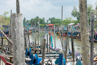 Boats moored in canal against sky in city