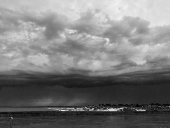 Scenic view of sea against storm clouds