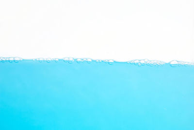 Close-up of bubbles over sea against clear blue sky