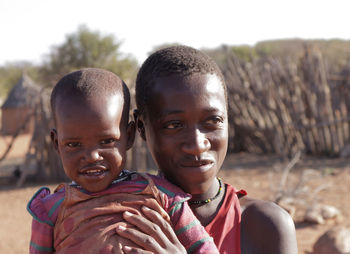 Close-up of smiling siblings