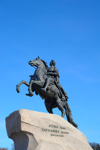 Low angle view of statue against clear blue sky