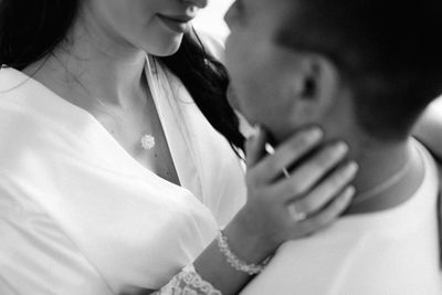 Midsection of couple kissing