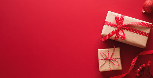 Directly above shot of christmas presents on red background