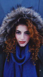 Close-up portrait of young woman in fur coat