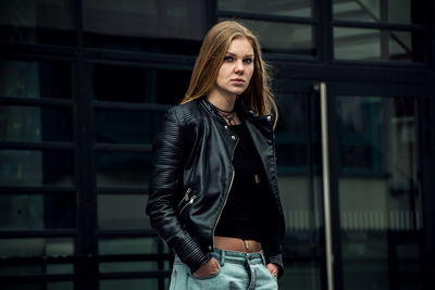 Portrait of beautiful young woman standing outdoors