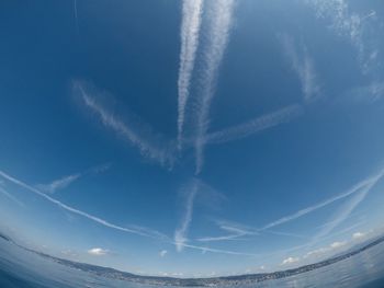 Low angle view of vapor trails in sky