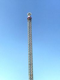 Low angle view of ferris wheel against clear sky