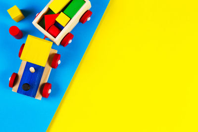 High angle view of multi colored toy on yellow background