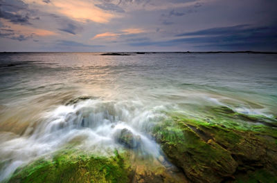 Scenic view of sea against cloudy sky