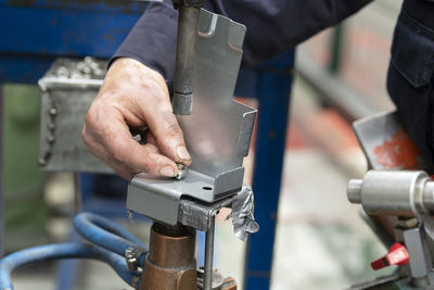 Close-up of man working on machine