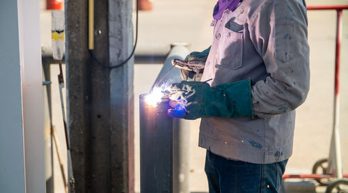 Rear view of man working at construction site