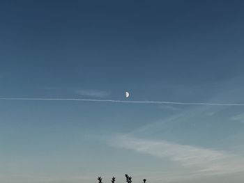 Low angle view of vapor trail