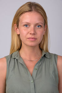 Portrait of beautiful young woman against white background